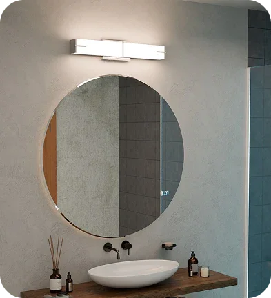 Modern bathroom vanity with round mirror, LED light fixture, and vessel sink